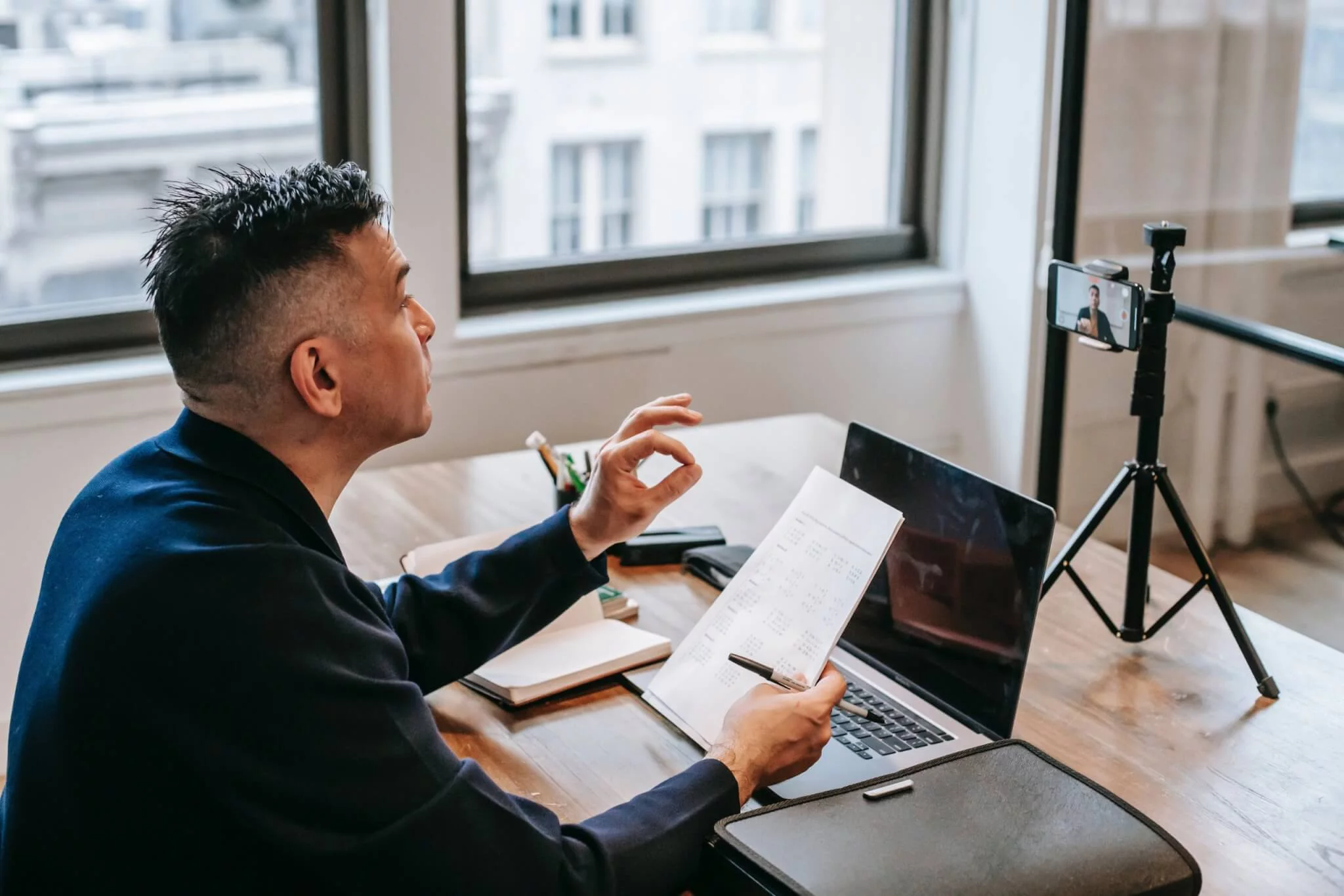 Teacher Hosting an Online Class with Students on a Video Call Platform Teacher leading a remote class using a webinar platform on a laptop, students visible on screen