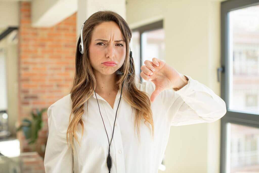 Disappointed attendee showing thumbs down after leaving a webinar