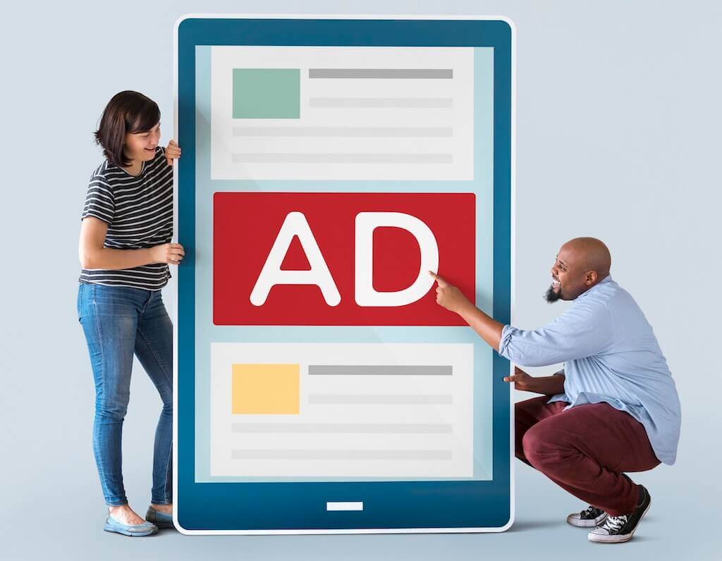 Two people presenting a large mobile screen with a bold ad banner to illustrate a webinar advertisement strategy